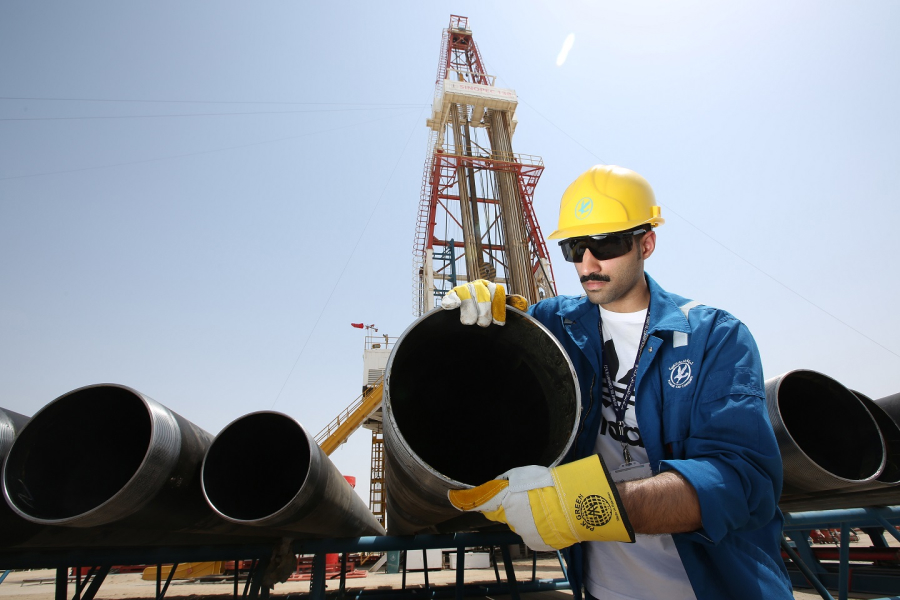 KOC employee working with pipe